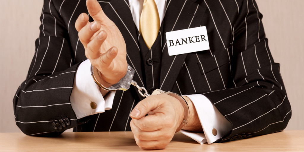 Banker in handcuffs